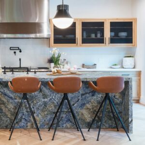 Blue Bahia granite kitchen island with blue-toned countertop and brown bar stools