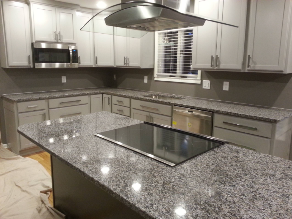 "New Caledonia Granite kitchen countertops featuring salt-and-pepper pattern"